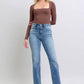 Model wearing Judy Blue vintage wash thermal straight jeans, showcasing a classic fit and stylish brown long-sleeve top.