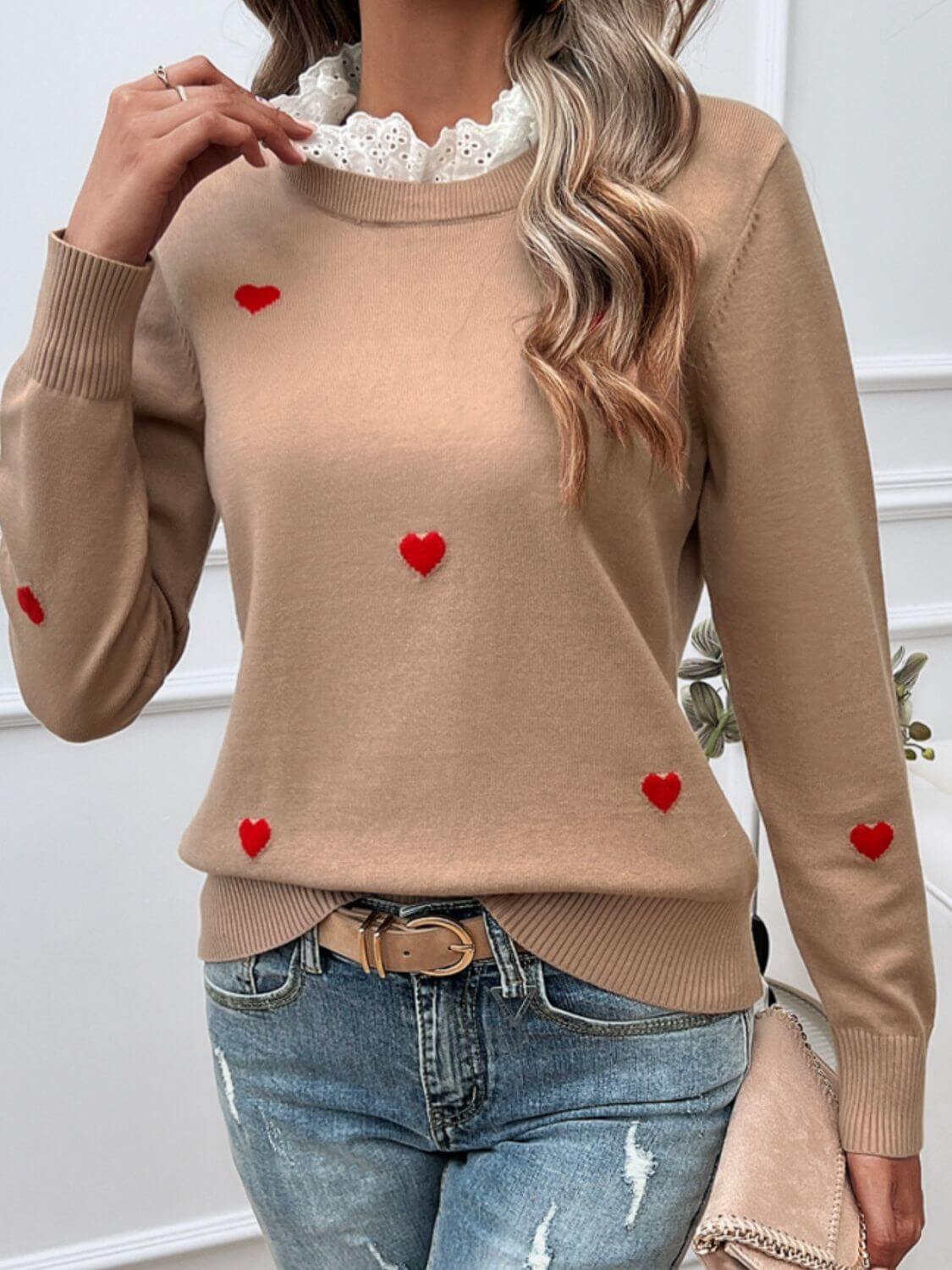 Woman wearing Devine Lace Detail Heart Long Sleeve Sweater in beige with red heart accents and jeans, casual chic style.