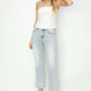 Woman wearing RISEN Full Size Mid Rise Cropped Flare Jeans paired with a white strapless top and nude heels.