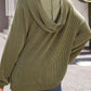 Textured kangaroo pocket long sleeve hoodie in olive green worn by model with back view, emphasizing ribbed fabric and hood.