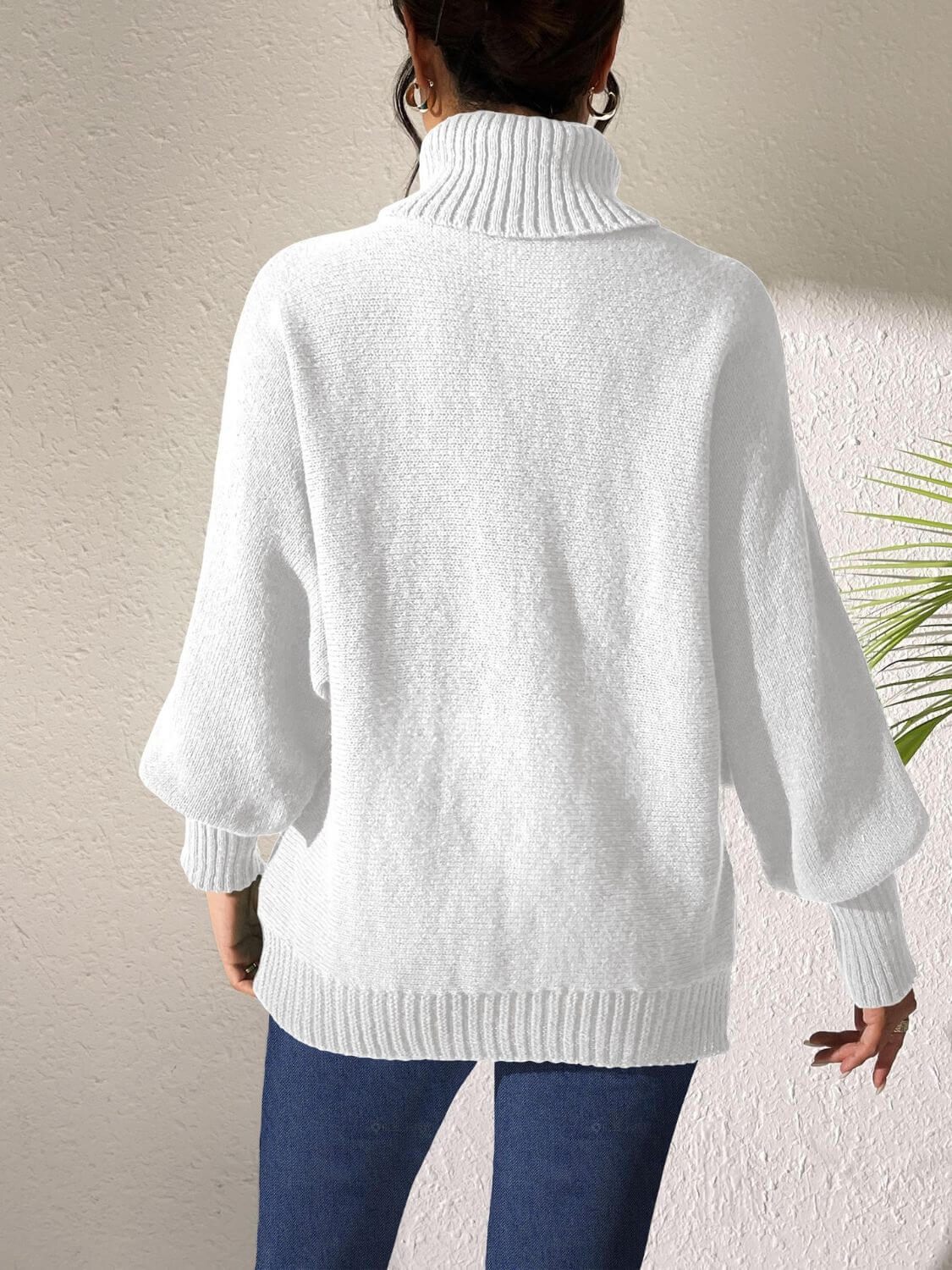 Woman wearing Bella Road Lip Turtleneck Long Sleeve Sweater in white, showcasing back view and stylish design.