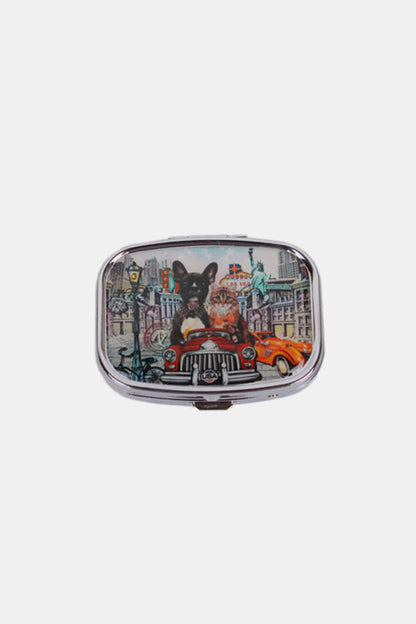 Nicole Lee USA Print Metallic Rectangular Pill Case with dog and cityscape design on the front, silver-tone metal exterior, push lock closure.