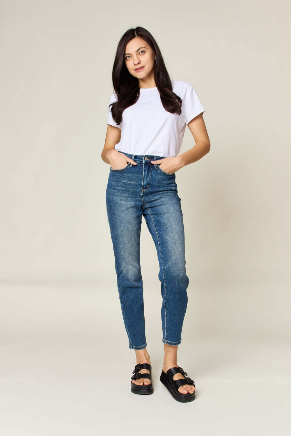 Woman wearing Tummy Control High Waist Slim Judy Blue Jeans in full size, providing a flattering silhouette with midsection support