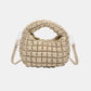 Beige quilted puffy crossbody bag with removable strap and unique design, perfect for elevating fashion style and versatility.