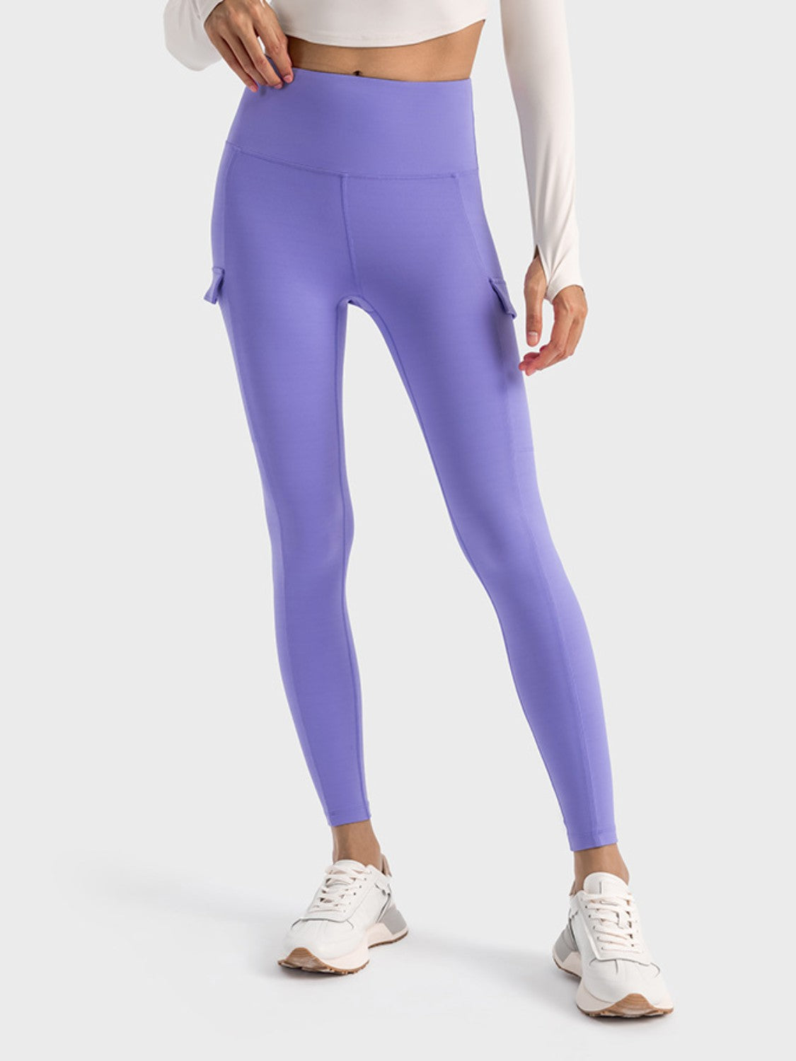 Stylish Millennia wide waistband sports leggings in purple with pockets, perfect for workouts and everyday wear.