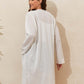 Woman wearing Lace Detail Open Front Long Sleeve Cover-Up in white, showcasing back view with sheer fabric and long sleeves.