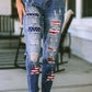 Woman wearing Bella Road distressed straight jeans with American flag patches and white sandals