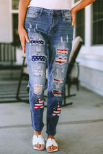 Woman wearing Bella Road distressed straight jeans with American flag patches and white sandals