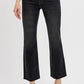 Woman wearing black cropped straight jeans with tummy control for a flattering fit and modern style.