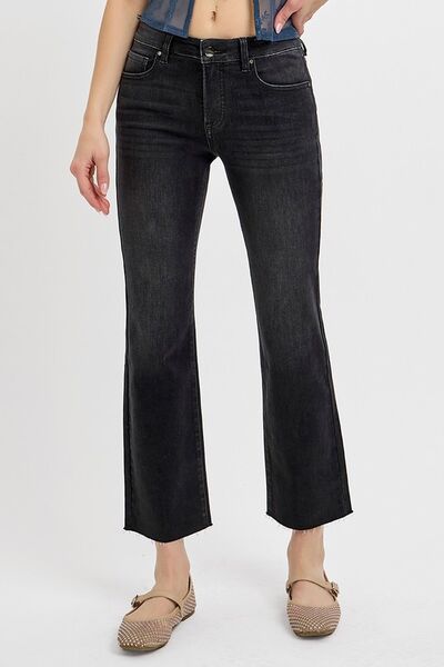 Woman wearing black cropped straight jeans with tummy control for a flattering fit and modern style.