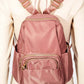 Stylish pink nylon backpack bag with multiple pockets and adjustable straps, perfect for daily adventures.