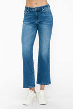 Mid-rise ankle jeans in light blue denim, featuring a stylish wide-leg cut and paired with casual white sneakers.