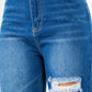 High waist distressed wide leg jeans close-up showing button waist closure and distressed trim on non-stretch denim fabric