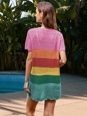 Woman wearing Bella Road Swim Openwork Cover-Up with rainbow stripes by a pool, showcasing summer style and comfort.