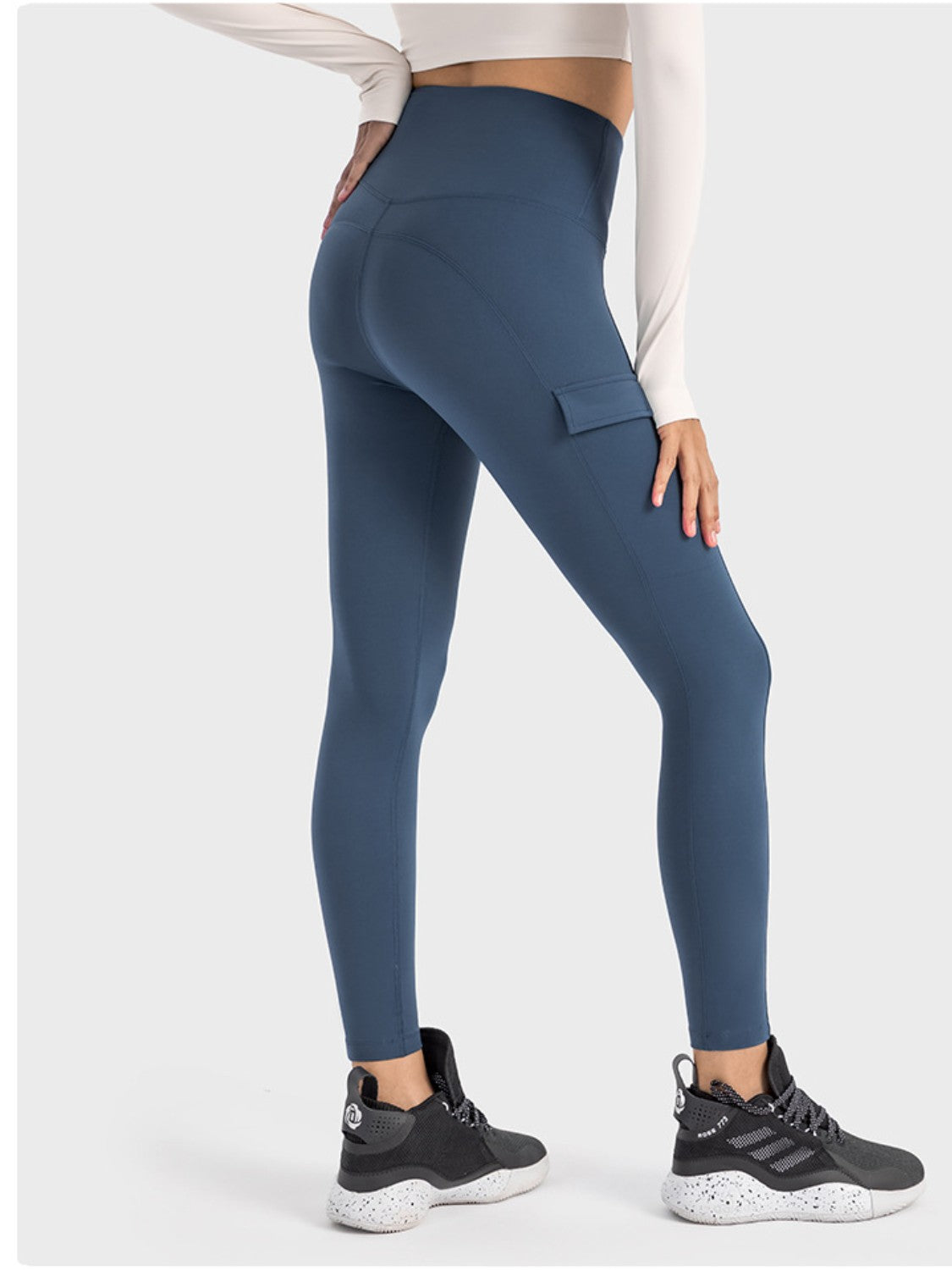 Stylish Millennia wide waistband sports leggings with pockets, perfect for workouts and casual wear in a rich blue color.