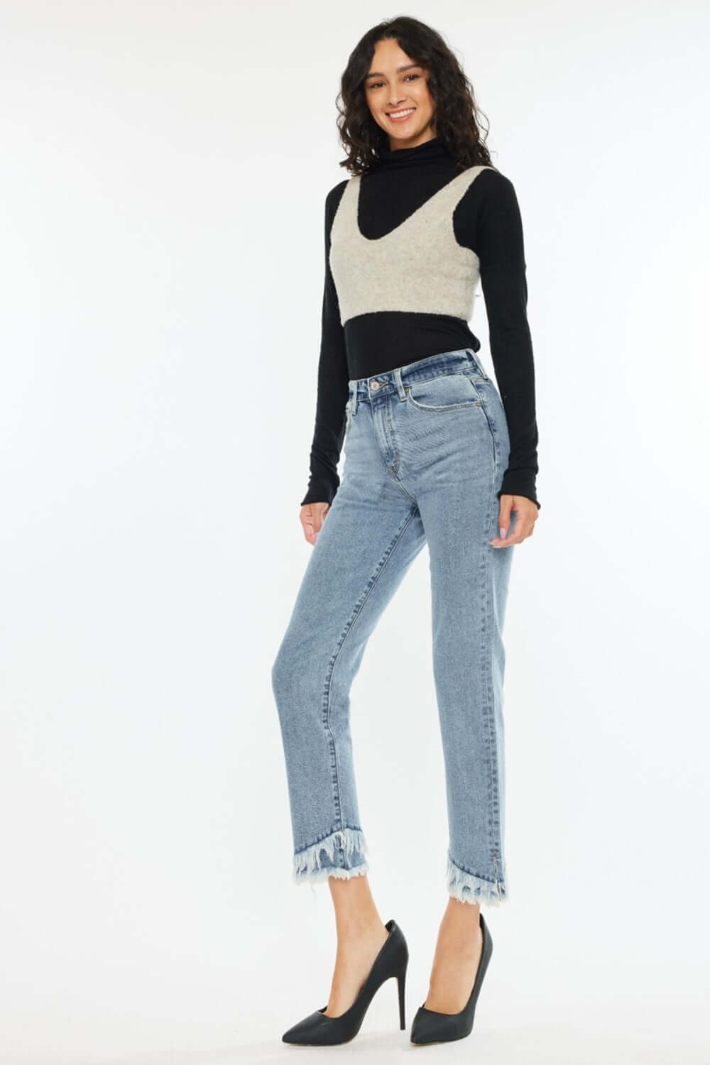 Woman wearing raw hem high rise straight jeans for a chic and casual look