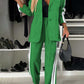 Stylish woman in a vibrant green two-piece blazer and pants set with white stripes, perfect for chic casual wear.