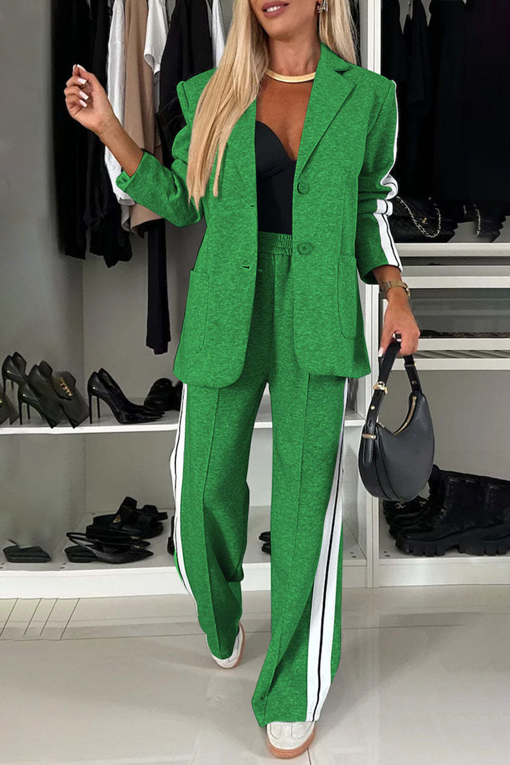 Stylish woman in a vibrant green two-piece blazer and pants set with white stripes, perfect for chic casual wear.