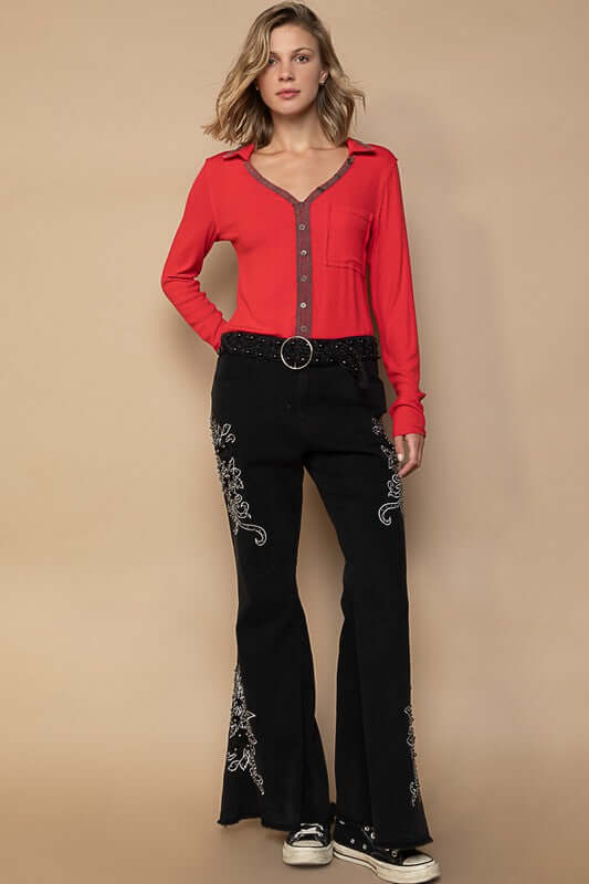 Stylish model wearing POL Raw Hem Embroidered Flare Pants with red top, showcasing bohemian and retro fashion vibes.