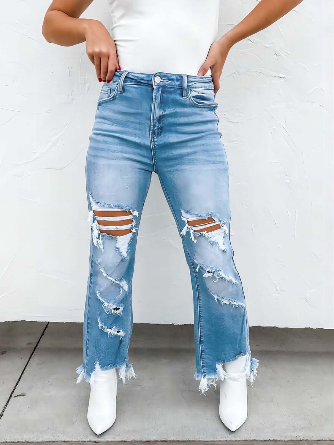 Bella Road distressed raw hem jeans with pockets in light blue, featuring a moderate stretch, perfect for casual wear.