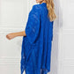 JUSTIN TAYLOR Pom-Pom Asymmetrical Poncho Cardigan in Blue at Bella Road