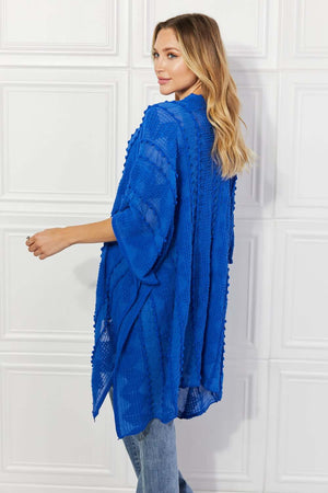 JUSTIN TAYLOR Pom-Pom Asymmetrical Poncho Cardigan in Blue at Bella Road