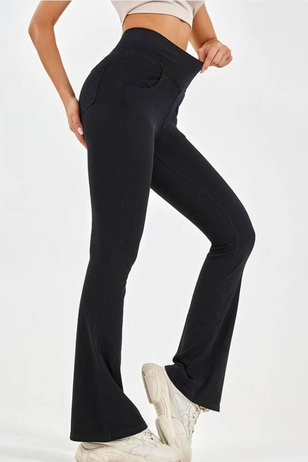 Model showcasing black highly stretchy bootcut jeans with pockets, emphasizing comfort and style.