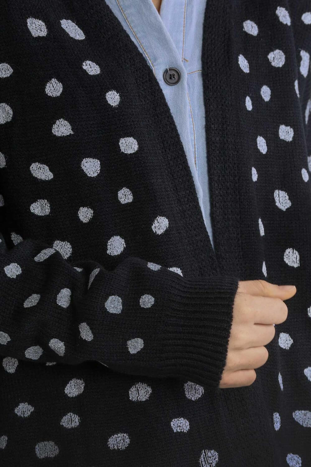 Stylish black polka dot cardigan with drop shoulder design, perfect for layering and effortless style!