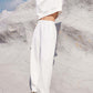 Fashion-forward white Bella Road top and pants set showcased outdoors, perfect for trendy style and comfort on any occasion.