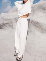 Fashion-forward white Bella Road top and pants set showcased outdoors, perfect for trendy style and comfort on any occasion.