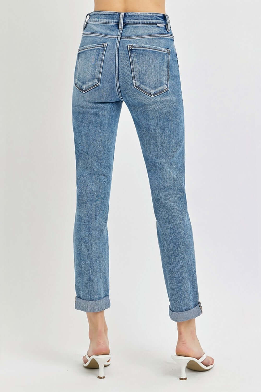 Back view of high rise cropped roll up jeans by Risen Jeans, showcasing stylish rolled-up cuffs and flattering fit, perfect with heels.