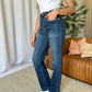 Woman wearing RFM Full Size High Rise Straight Tummy Control Jeans, standing indoors, showcasing the flattering high-waist design and straight-leg cut