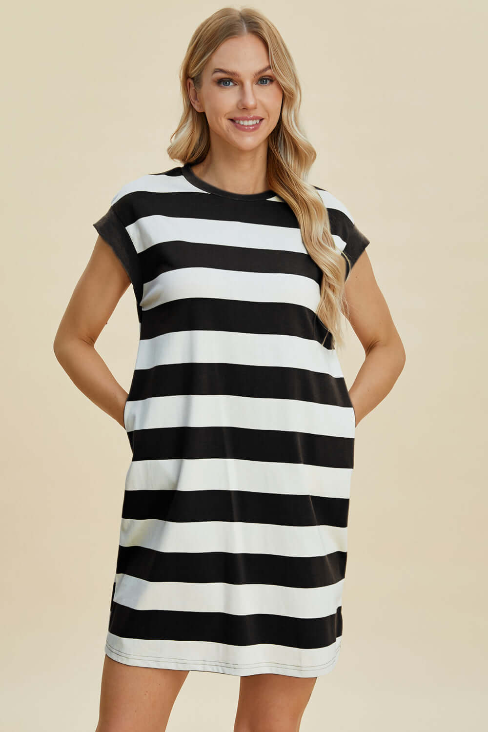 Woman wearing Basic Bae full-size striped round neck cap sleeve mini dress in black and white