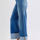 Judy Blue distressed high waist wide leg jeans showcasing a stylish silhouette and trendy hem detail.