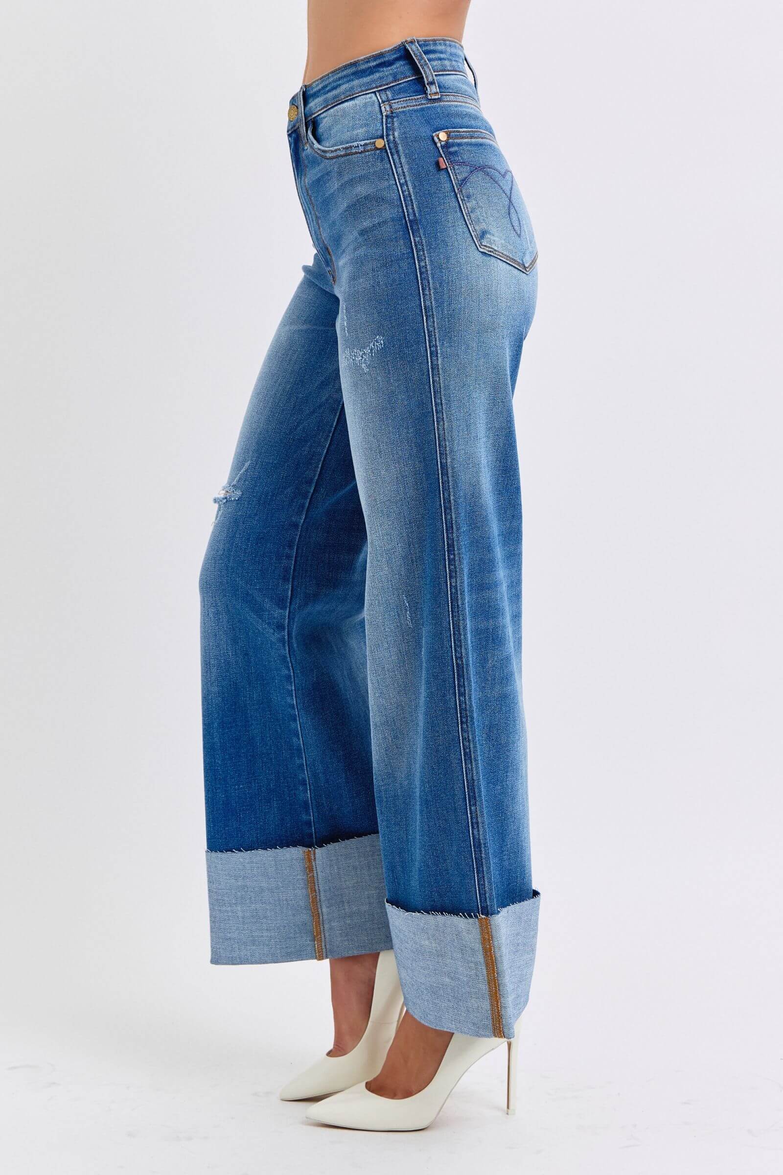 Judy Blue distressed high waist wide leg jeans showcasing a stylish silhouette and trendy hem detail.