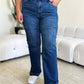 Woman wearing Judy Blue High Waist Straight Cargo Jeans standing in a modern living room.