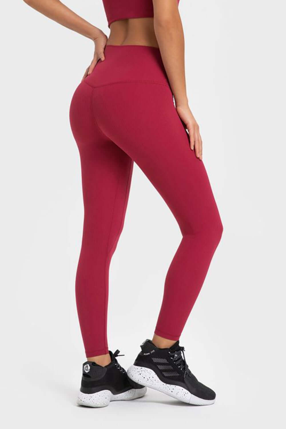 Model showcasing Millennia Highly Stretchy Wide Waistband Yoga Leggings in vibrant burgundy, perfect for yoga and workouts.