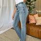 Judy Blue full-size medium rise bootcut jeans in a stylish living room setting, showcasing a flattering fit and versatile style.