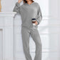 Woman wearing Bella Road gray hoodie and pants set, sipping coffee in style. Cozy, trendy, and perfect for lounging or errands.