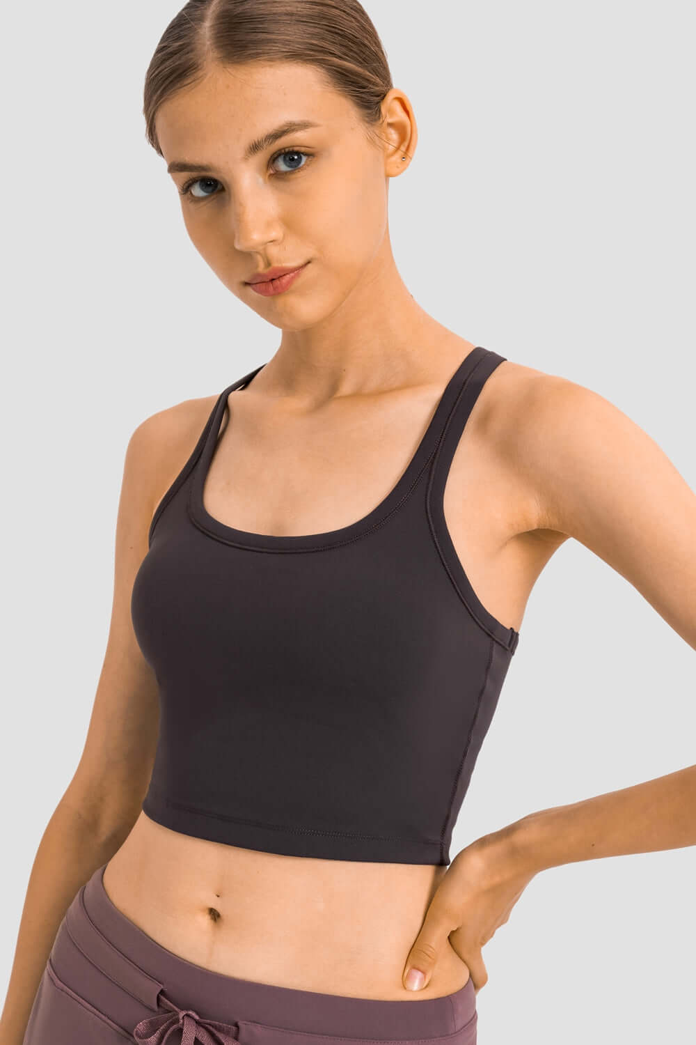 Millennia Racerback Sports Bra in sleek black, perfect for yoga with removable padding and a sporty slim fit.