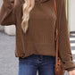 Woman wearing textured kangaroo pocket long sleeve hoodie with jeans and a brown shoulder bag.