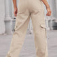 Woman wearing Baeful Long Straight Leg Jeans with Pockets in solid beige, showcasing a casual and chic style against an urban backdrop