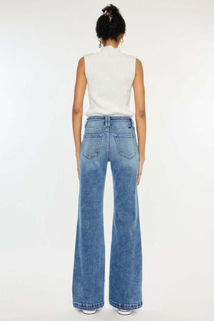 Woman wearing Kancan high-rise wide leg jeans in medium wash, showcasing flattering fit and style from the back.