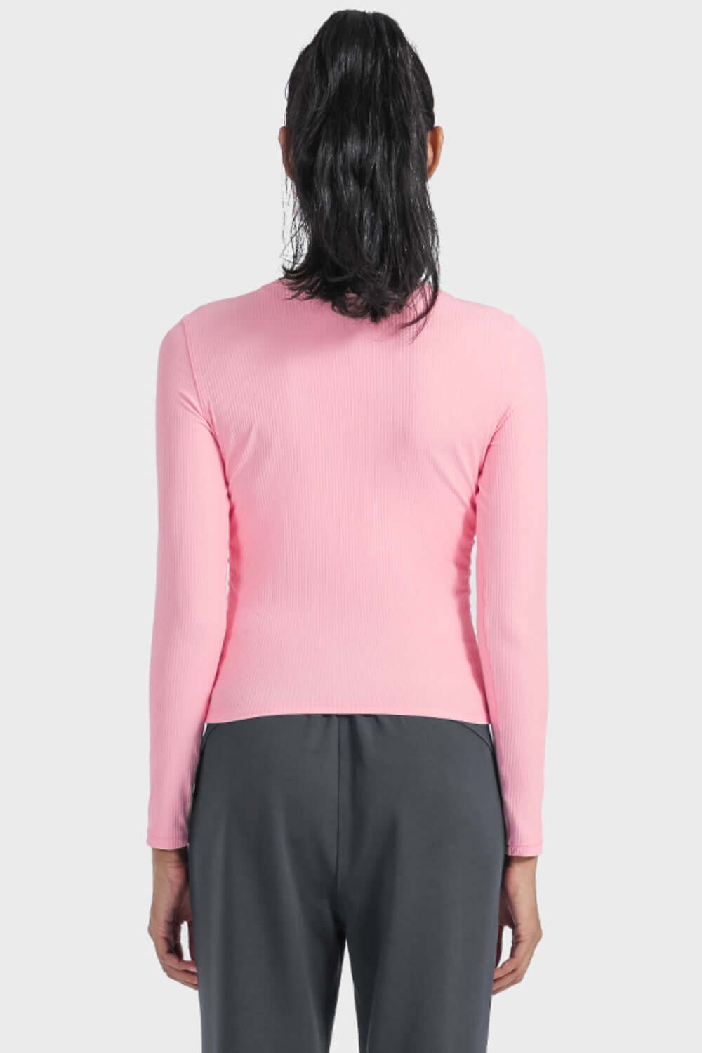 Back view of a pink Millennia round neck long sleeve sports top, perfect for workouts or casual lounging.