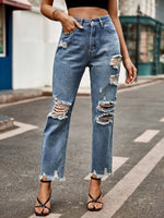 Woman wearing Bella Road distressed raw hem jeans with pockets, slightly stretchy denim, buttoned fly, and stylish ripped details.