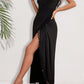 Woman wearing a black backless tassel surplice spaghetti strap cover up dress with a side slit and sheer tassel details