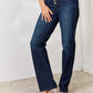 Woman wearing Judy Blue high waist button-fly straight jeans in dark wash with slight stretch and pocketed design