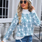 Woman in Angel Wings Flower Turtleneck Sweater with beret, standing stylishly outside in blue jeans and sunglasses.