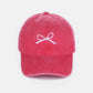 Stylish pink cotton cap with delicate white bow embroidery on the front, offering a charming and breathable accessory for all-day wear.