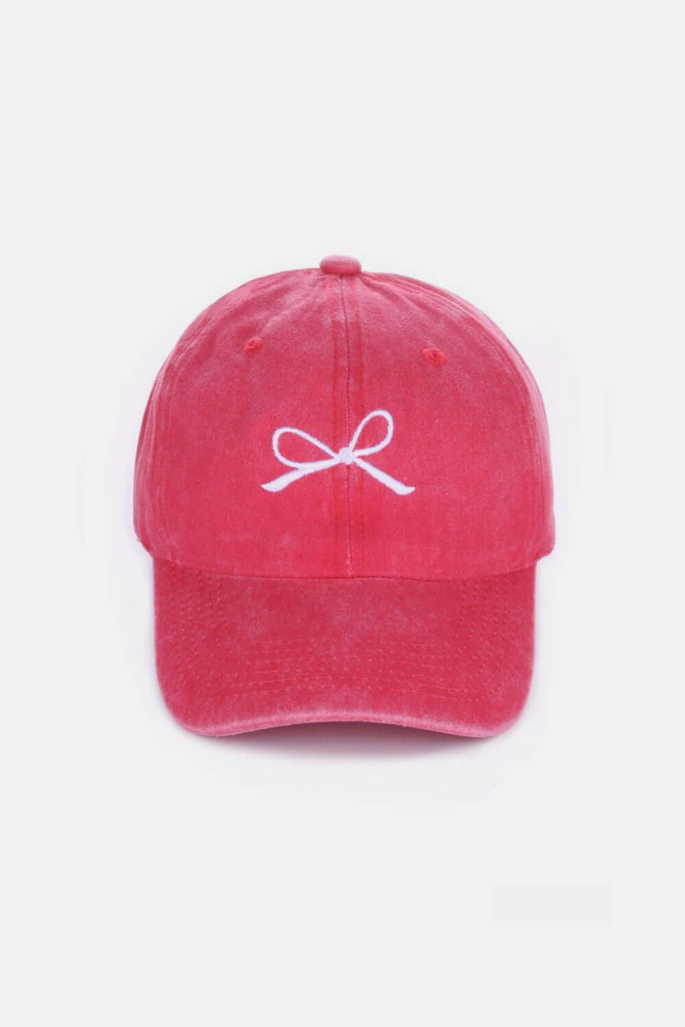 Stylish pink cotton cap with delicate white bow embroidery on the front, offering a charming and breathable accessory for all-day wear.